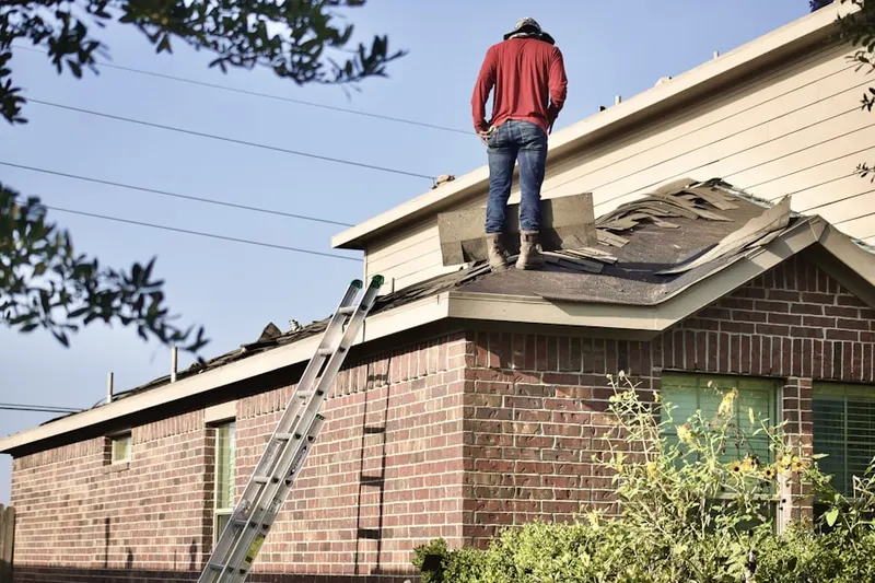 Professional roofer working on a residential roof in Short Hills